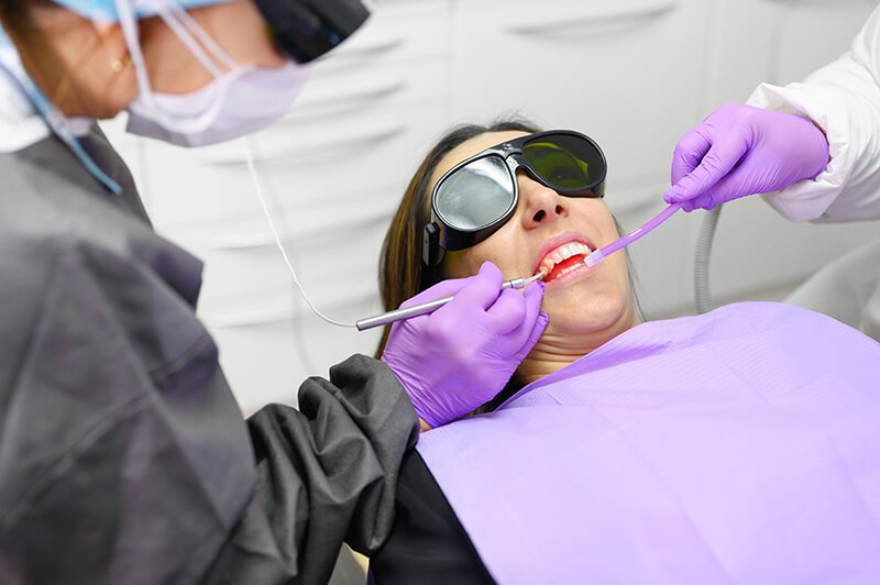 a dentist is performing a dental checkup on a patient
